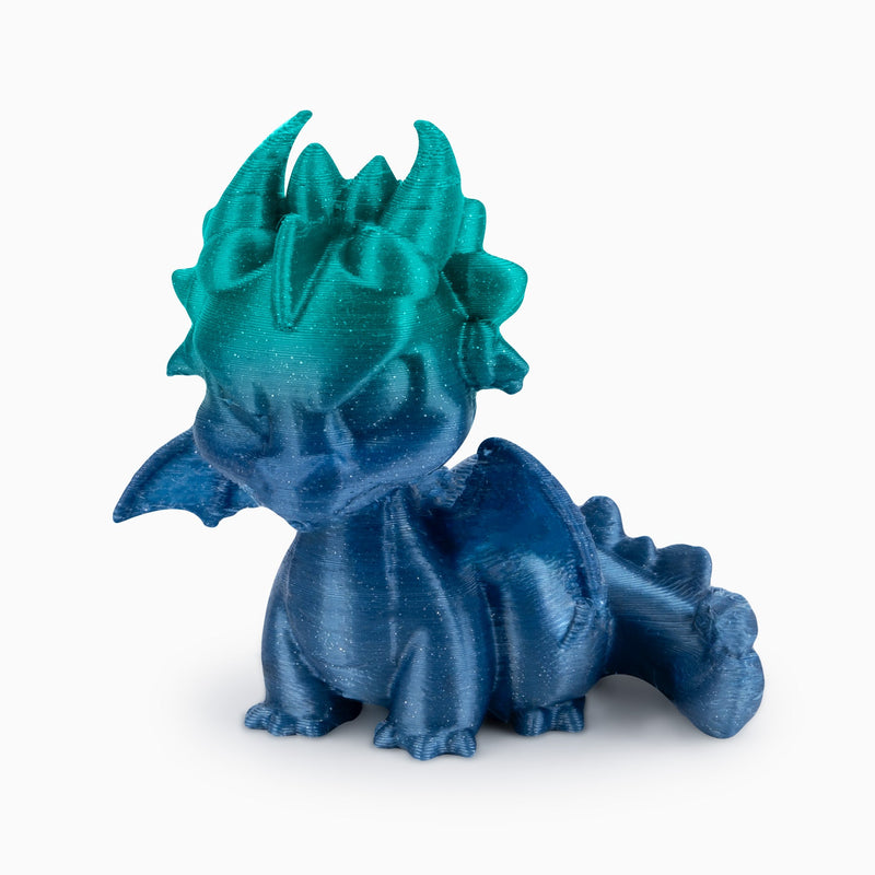 Shiny gradient PLA silk filament 1.75mm by Amolen, 1kg spool showing vibrant color transitions and smooth texture.