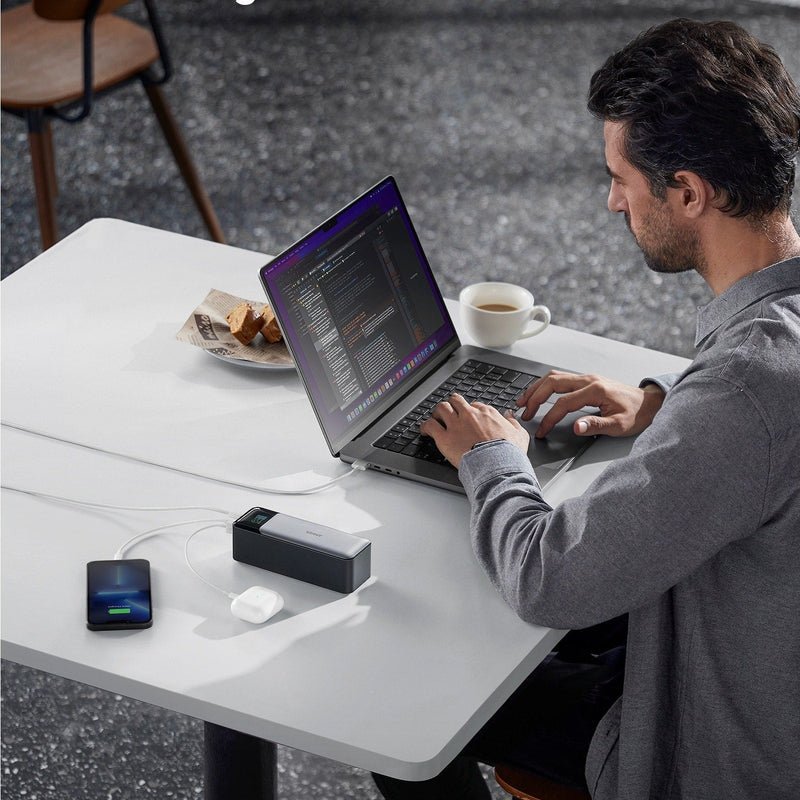 Black Anker 737 PowerCore 24K portable power bank for charging devices, featuring multiple USB ports and compact design.