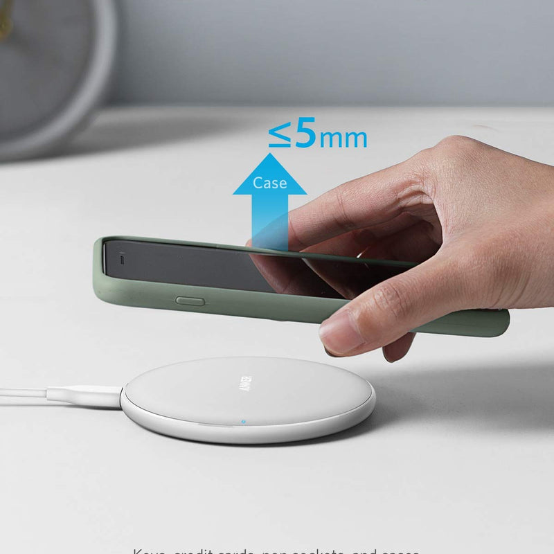 Anker 313 Wireless Charger Pad in black for charging devices wirelessly on a sleek, flat charging surface.