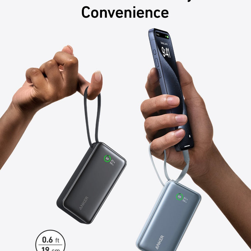 Anker Nano Power Bank in black with built-in USB-C cable, 30W portable charging device on a stone surface.