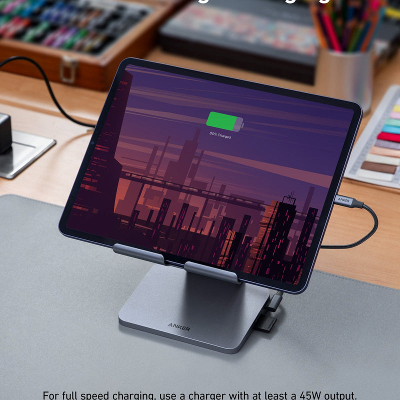 Anker 551 USB-C Hub in gray with tablet stand, featuring multiple ports for charging and connectivity.