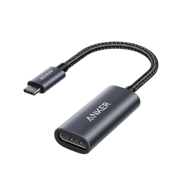 Anker PowerExpand USB-C to DisplayPort adapter connecting a laptop to a monitor with visible ports and cable.