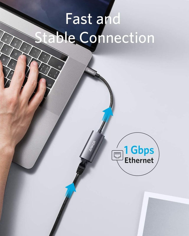 Anker PowerExpand USB-C to Gigabit Ethernet Adapter in gray, showing compact design and Ethernet port for wired network connection.