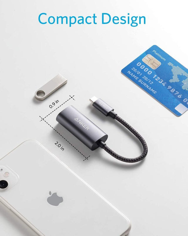 Anker PowerExpand USB-C to Gigabit Ethernet Adapter in gray connected to a laptop for wired internet connection.