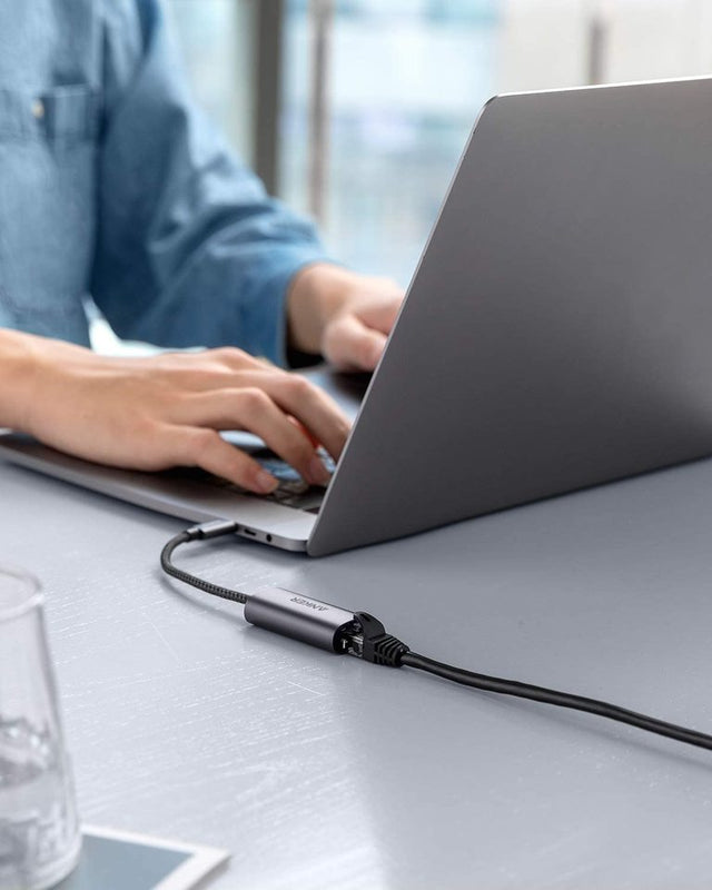 Anker PowerExpand USB-C to Gigabit Ethernet Adapter in gray, showing compact design and Ethernet port for wired internet connection.