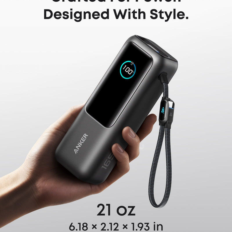 Anker 25K 165W laptop power bank in space black with built-in and retractable cables for portable charging.