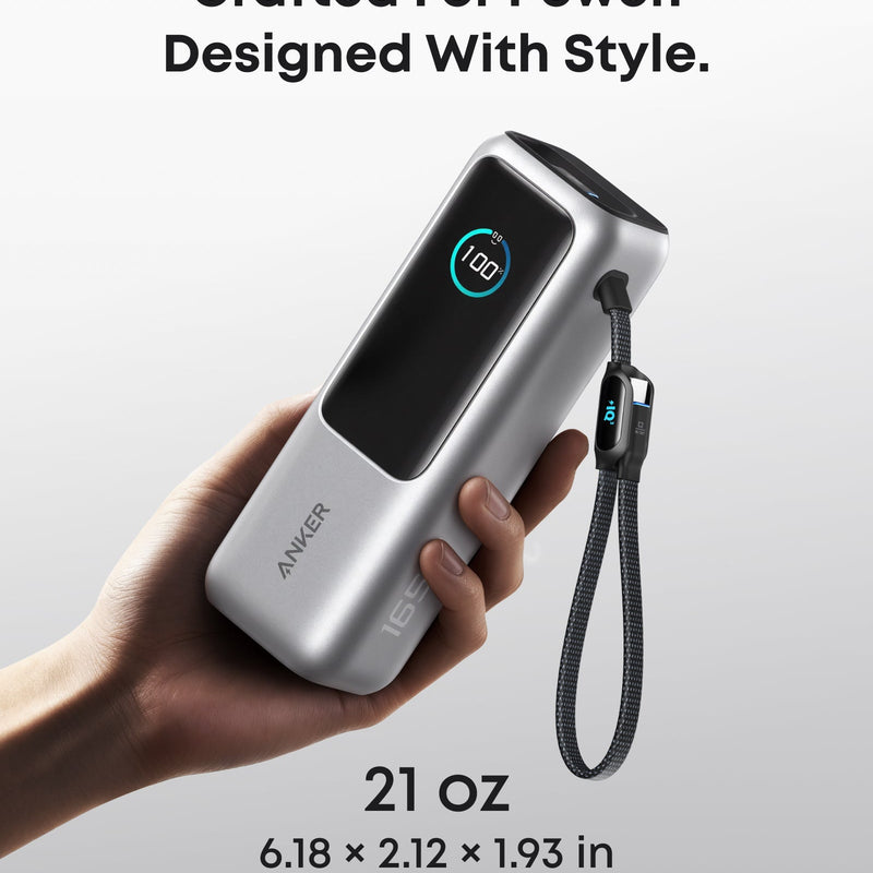 Anker 25K 165W laptop power bank in space black with built-in and retractable cables for portable charging.