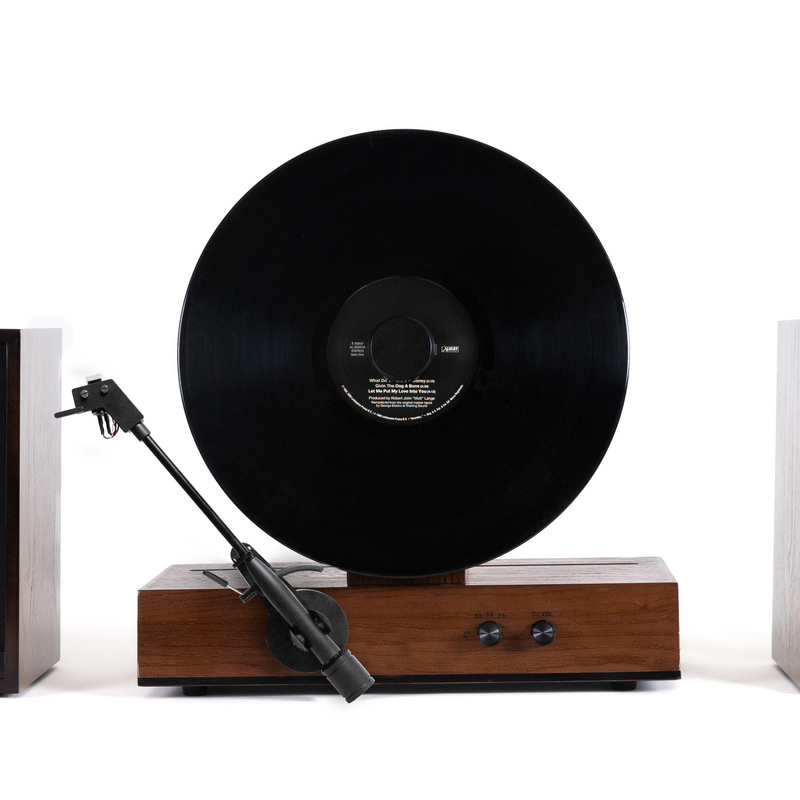 Fuse Audio GLD vertical vinyl record player, stylish gold turntable with modern design and tonearm for playing vinyl records.