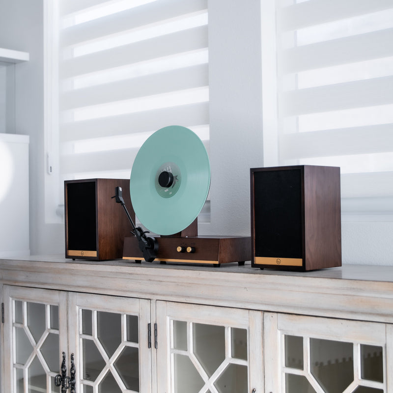 Fuse Audio GLD vertical vinyl record player, turntable with gold finish, showcasing sleek design and record spinning capabilities.